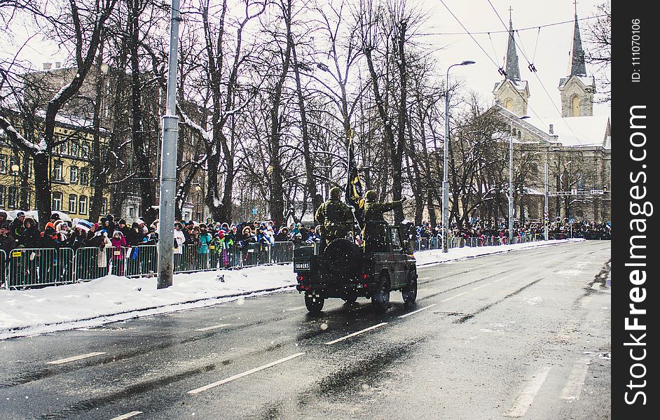 Soldiers Riding A Vehicle During A Parade