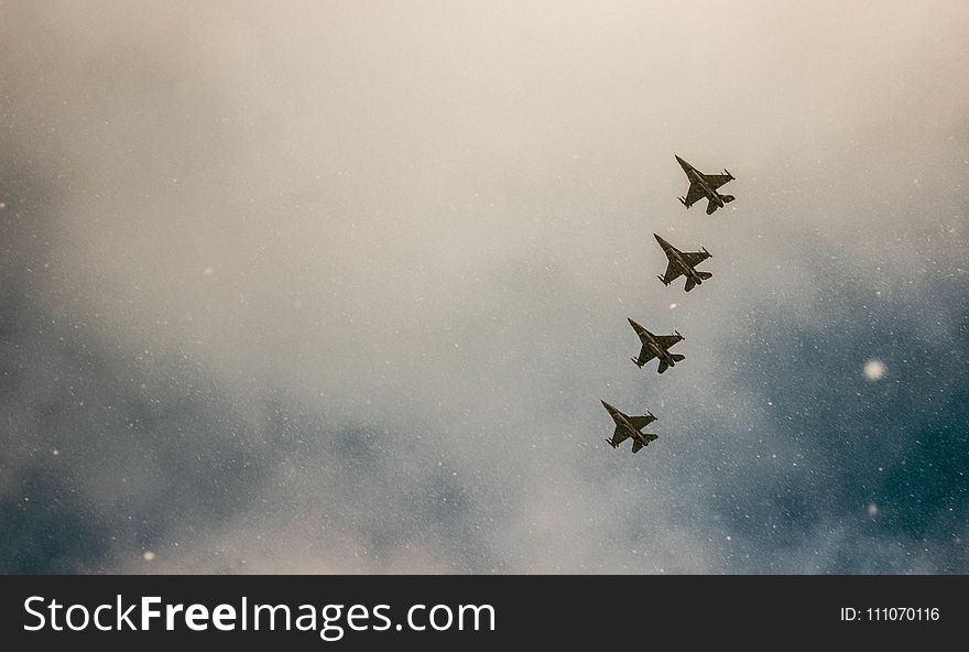 Four Gray Jet Planes on Sky