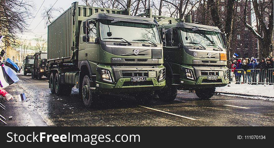 Two Green Dump Trucks on Gray Concrete Road