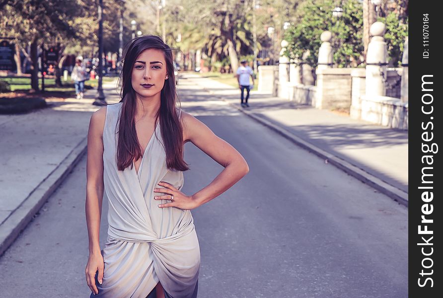 Woman Wearing Gray Sleeveless Slit Dress