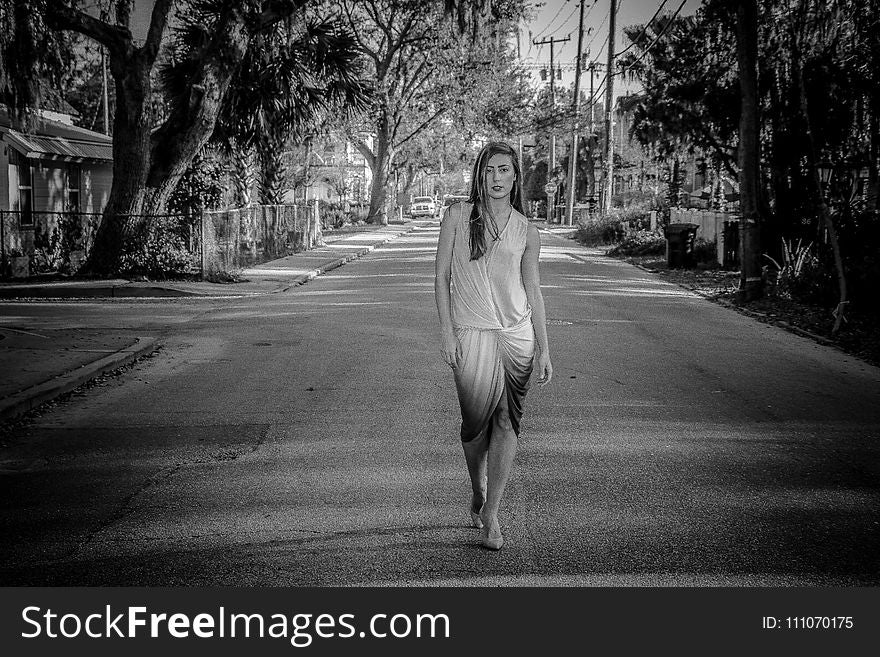 Greyscale Photo of Woman Standing on Street