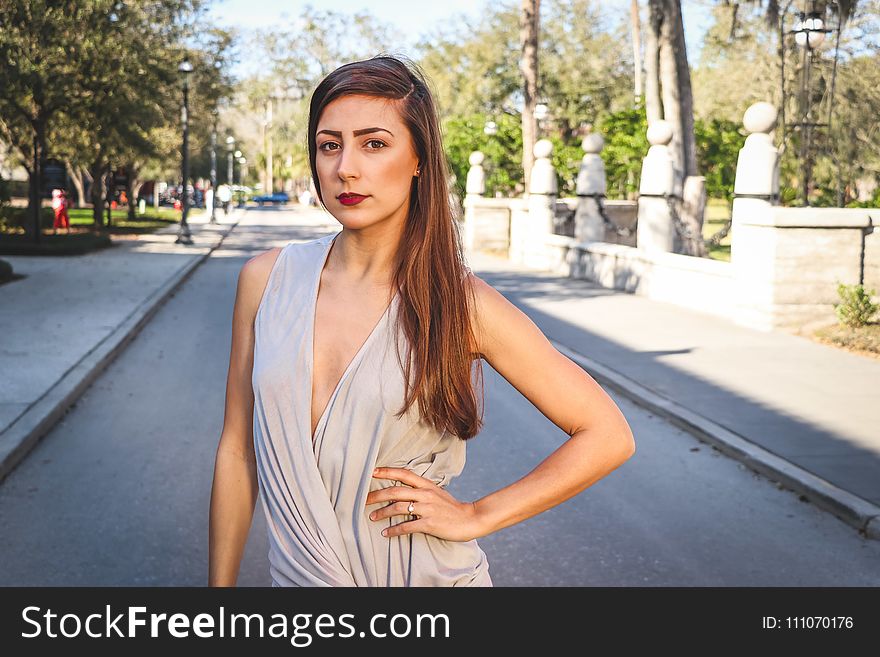 Woman Standing in the Middle of the Street