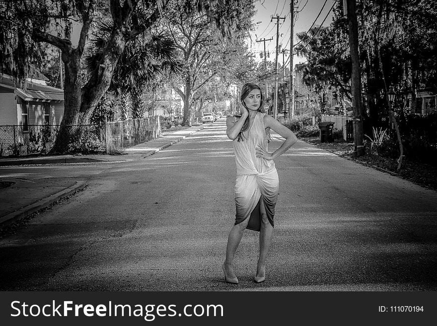 Woman Wearing Dress Standing on Center of Road