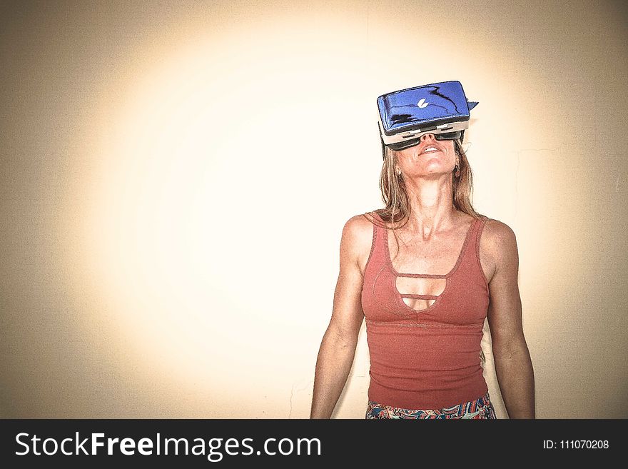 Woman in Brown Cages Sleeveless Top and Blue Virtual Reality Headset
