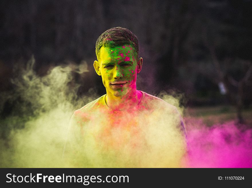 Man Painted With Green and Purple Paints Photo