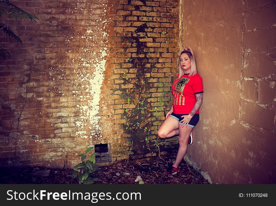 Woman Wearing Red Crew-neck Sleeved Shirt and Blue Denim Short Shorts