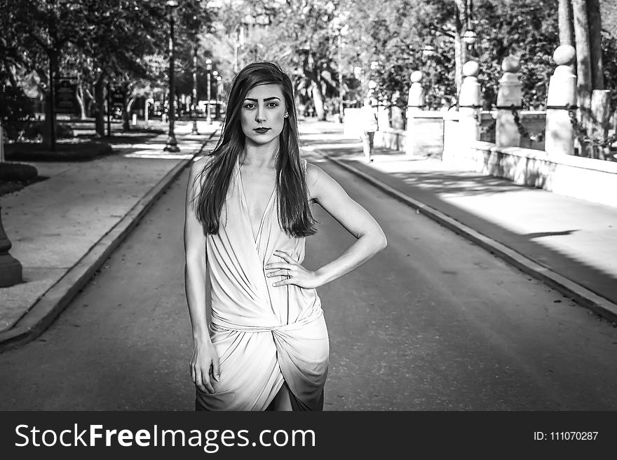 Woman Wearing Dress Standing on Grey Concrete Road