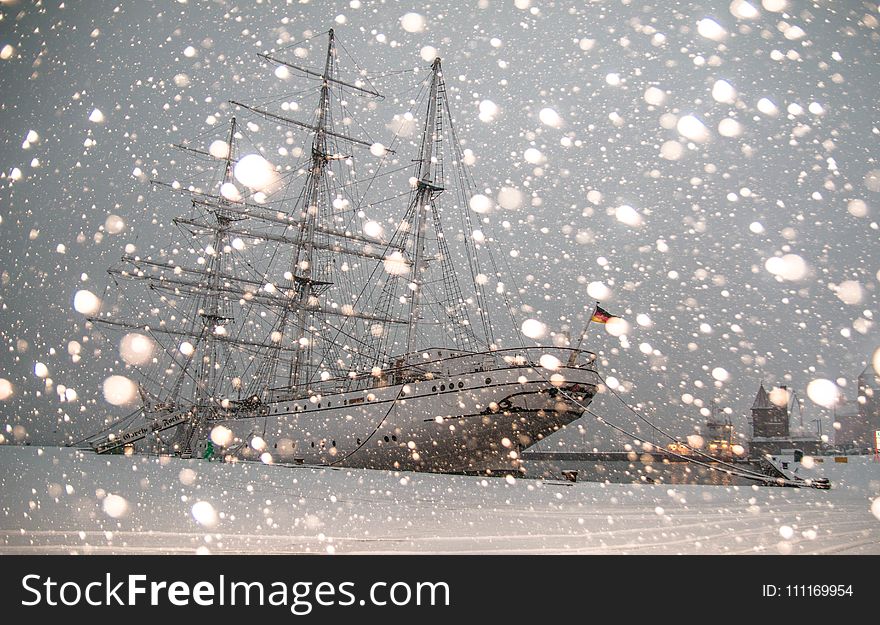 White Sailing Ship Docked at Pier