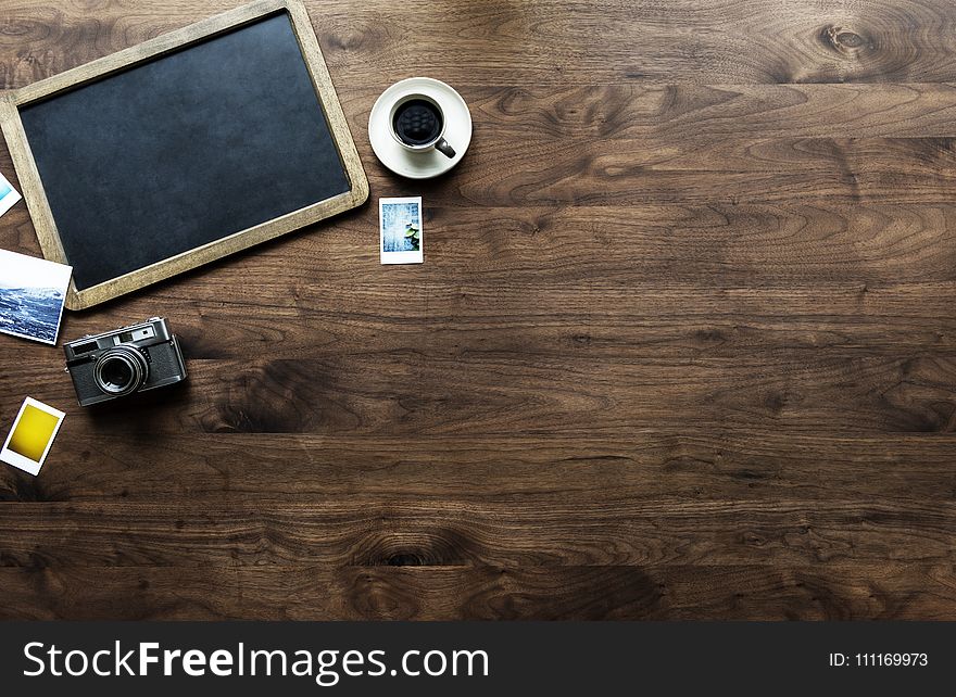 Photography of Tray, Coffee Cup and Camera on Table Top