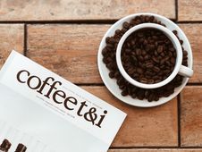 Free Coffee T&i Catalog And Cups And Saucers On Top Of Table Stock Photos - 111170093