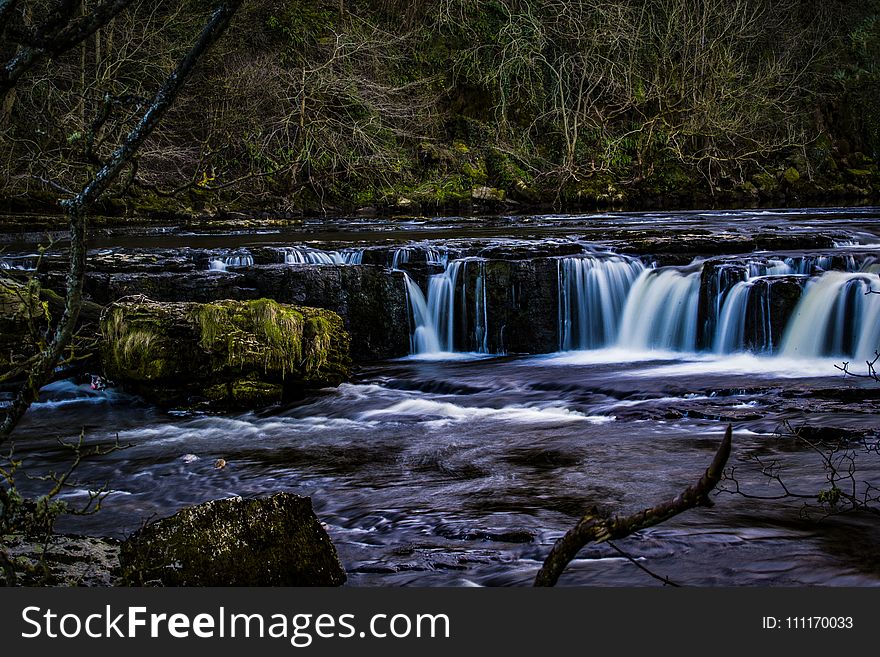 Selective Photo Of Body Of Water Surrounded By Trees And Big Rocks