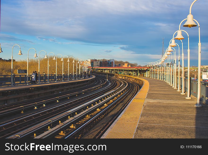 Train Railroad With White Light Posts Beside It