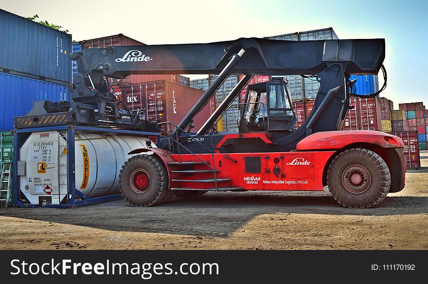 Red And Black Front-loader Beside Intermodal Containers