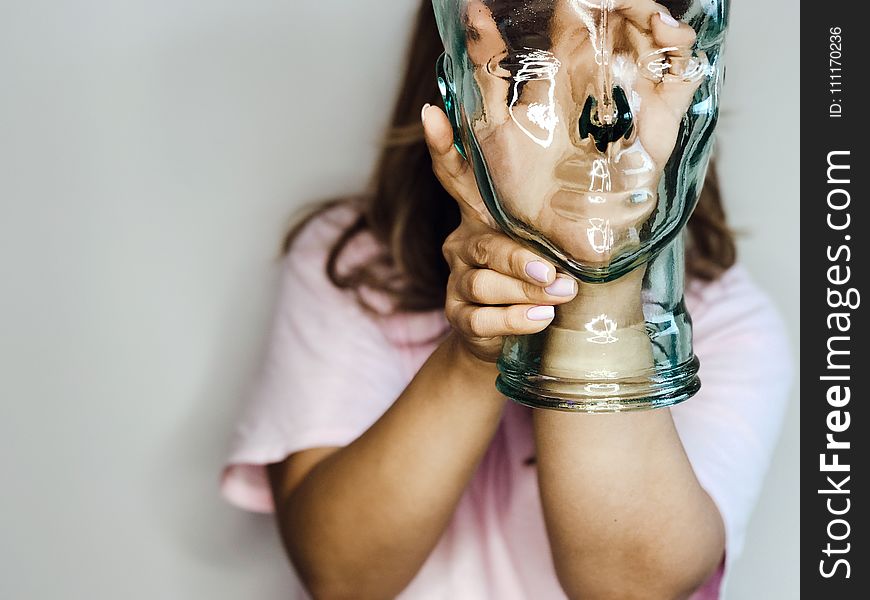 Woman&x27;s Hand Inside Glass Bottle