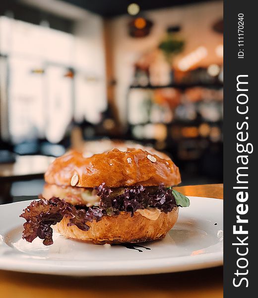 Selective Focus Photography of Burger on White Ceramic Plate