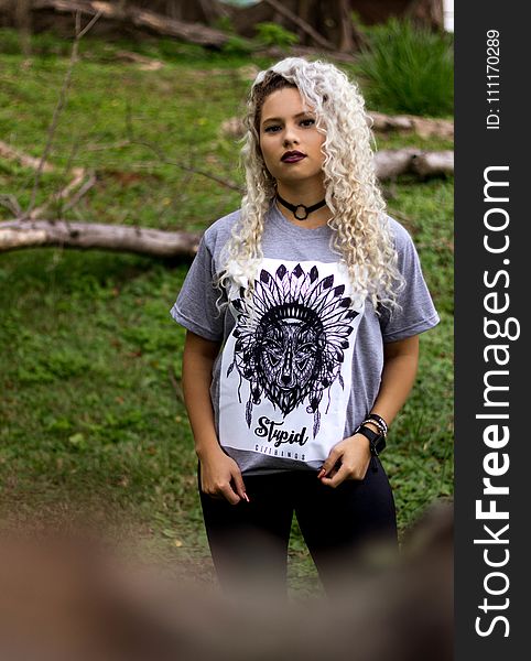 Woman Wearing Gray and Black Tribal Graphic Crew-neck Shirt and Black Pants