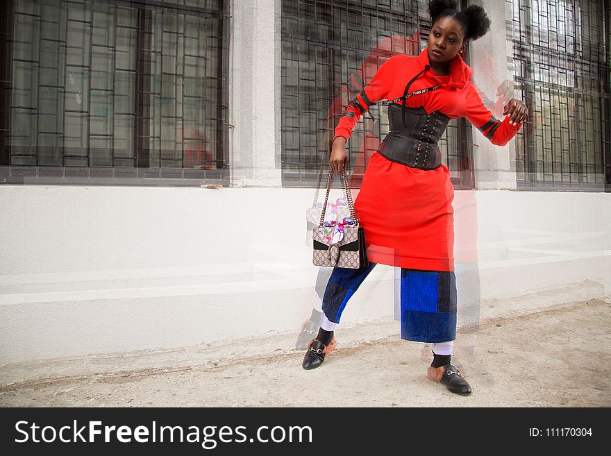 Woman in Red and Multicolored Shirt Dress Holding Bag