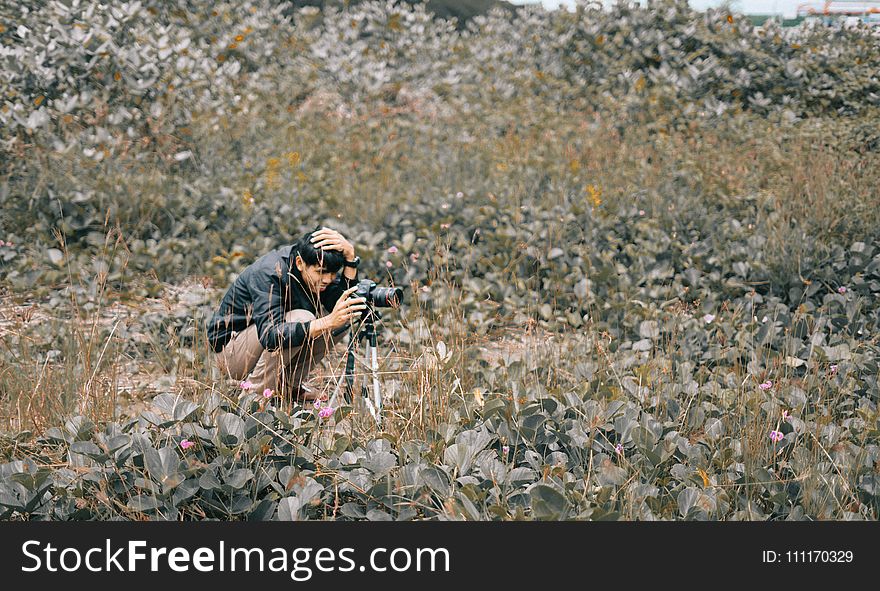 Man Taking Photo Using Dslr Camera