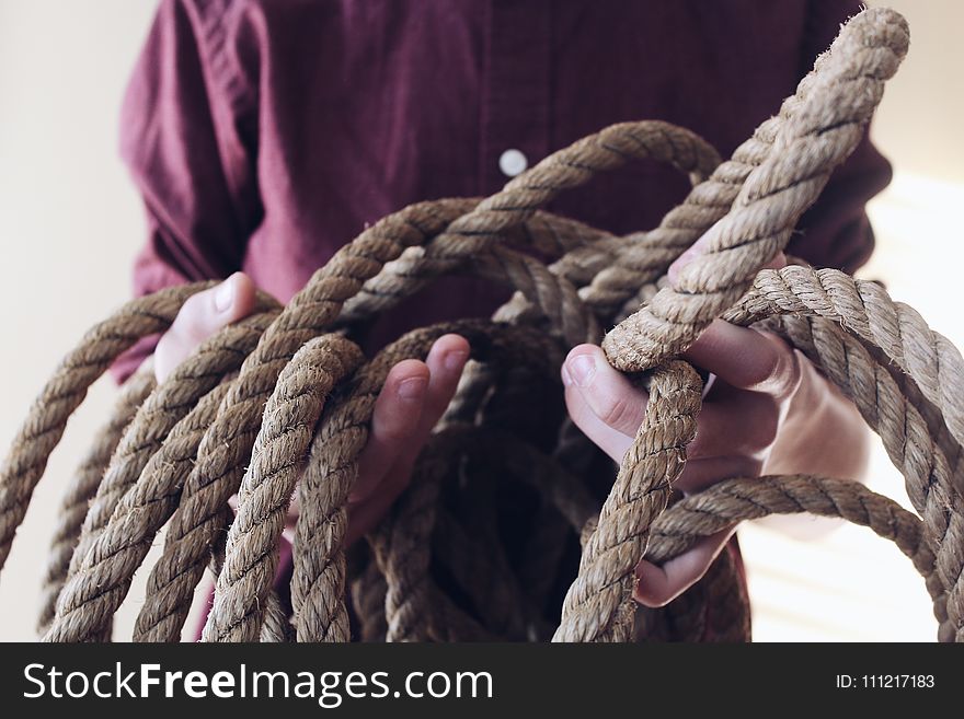 Close-up Photography of Man Holding a Rope