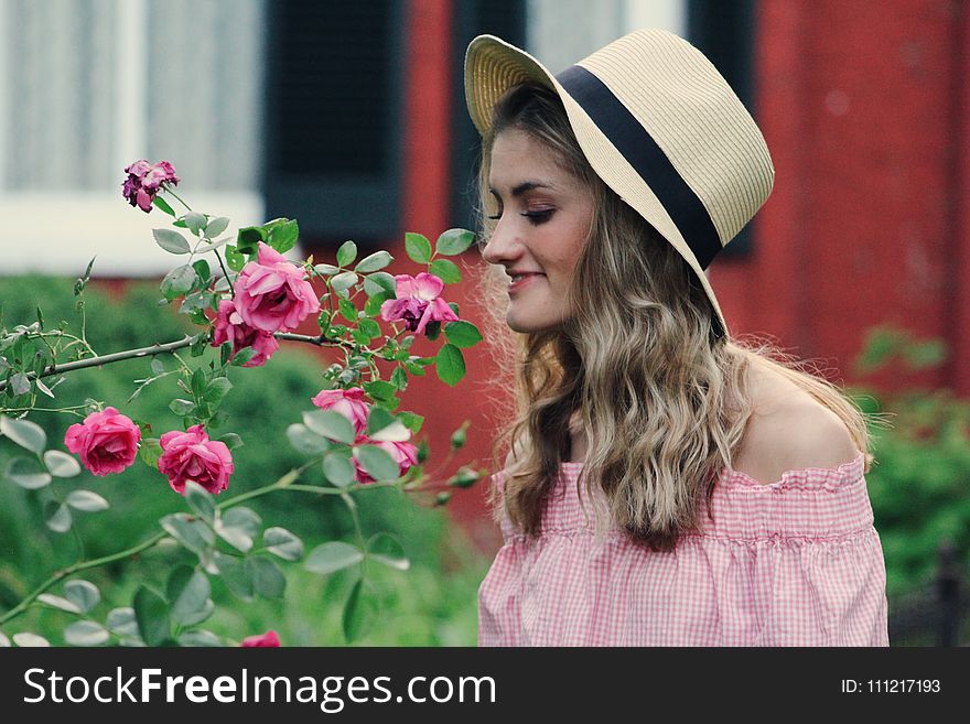 Photo of Woman Smelling Flowers