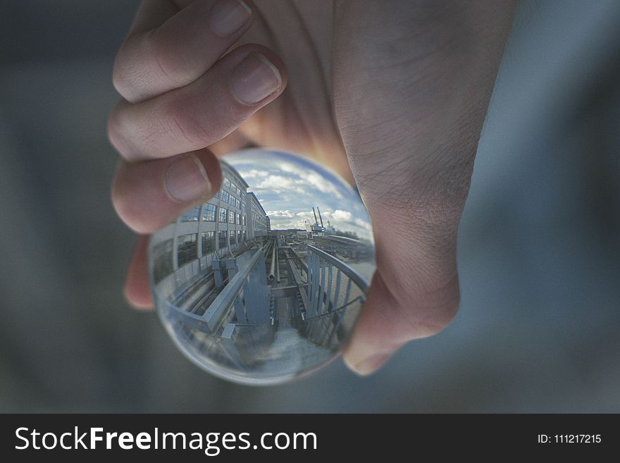 Person Holding Clear Glass Decor