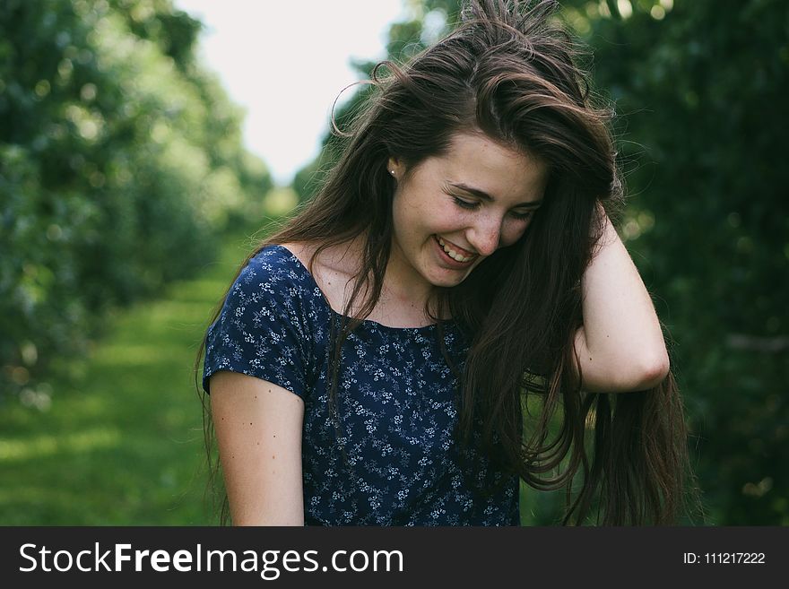 Photo of a Woman Holding Her Hair