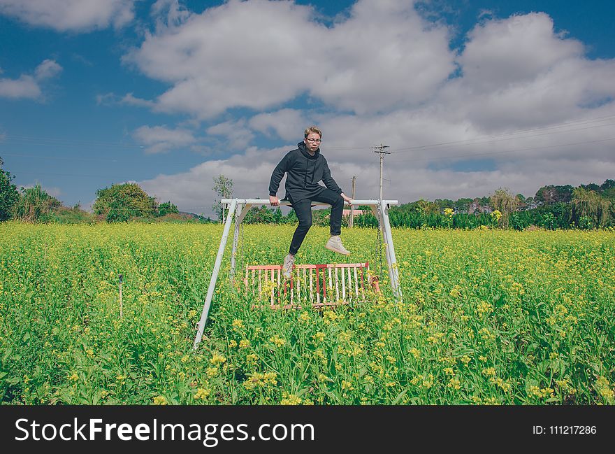 Man Sitting On White Swing