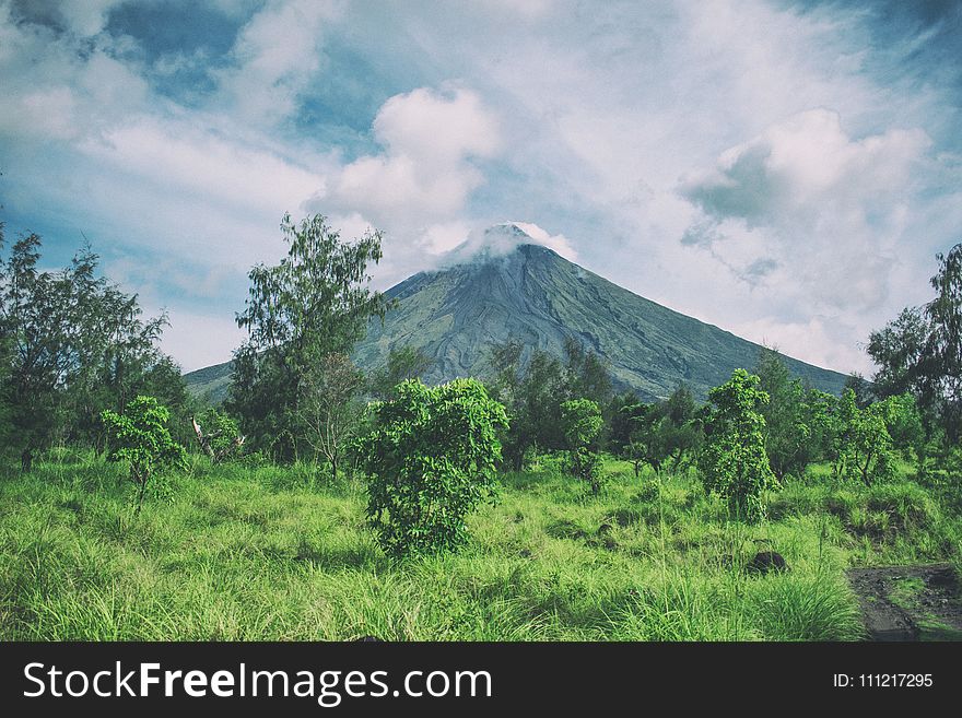 Landscape Photography Of Mountain Under Cloudy Sky