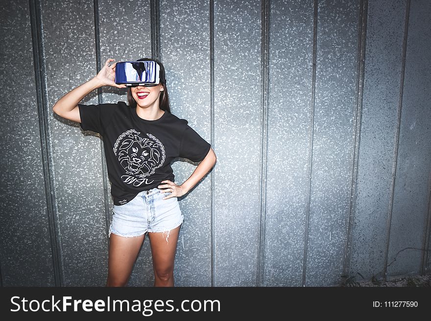 Woman in Black Crew-neck T-shirt Wearing Blue Vr Goggles