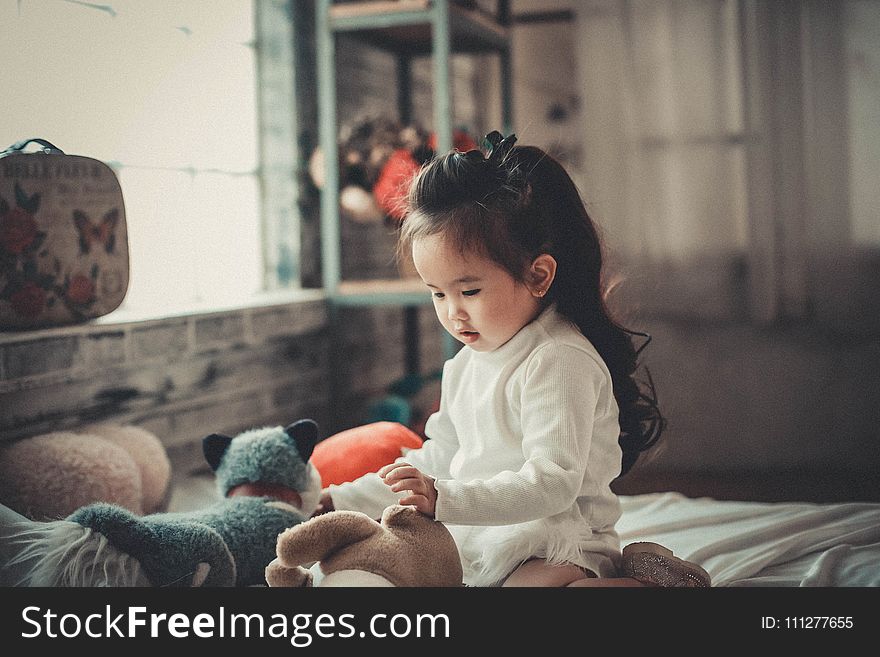 Photography of a Baby Girl Playing