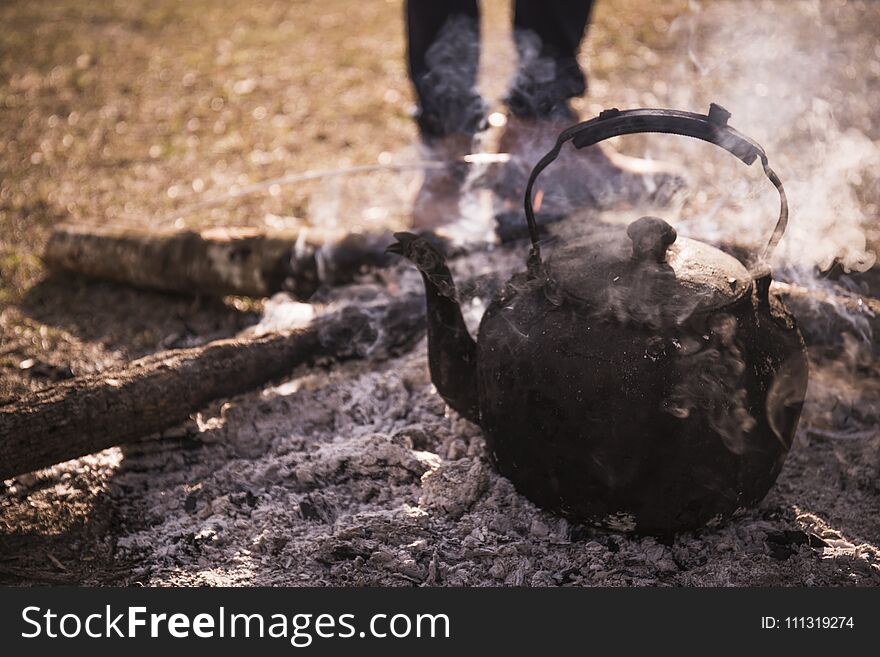 Kettle With Boiling Water Over A Campfire