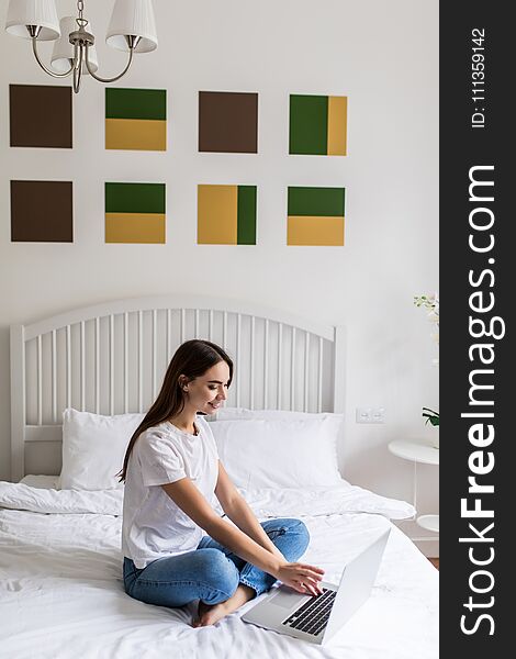 Woman Using Laptop Computer Lying On Bed. Closeup Portrait Of Happy Beautiful Girl Typing On Notebook Keyboard, Working Online At