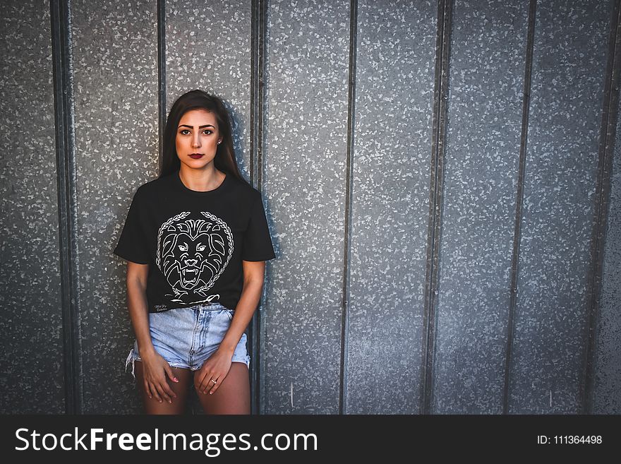 Woman Wearing Black Crew Neck Shirt And Blue Denim Shorts