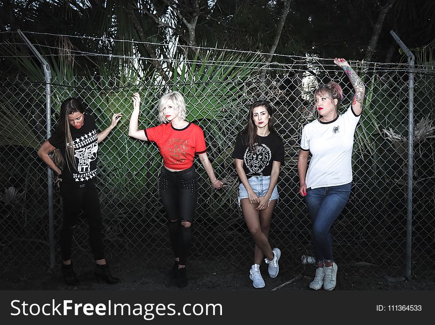 Group Of Women Beside Stainless Steel Cyclone Fence