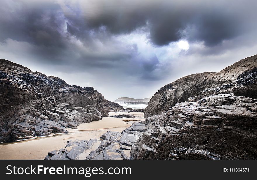 Gray Rock Formation Under Clouds At Daytime