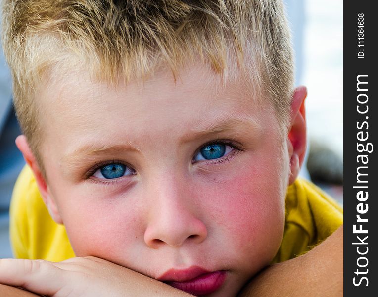 Close-Up Photography of Boy With Blue Eyes