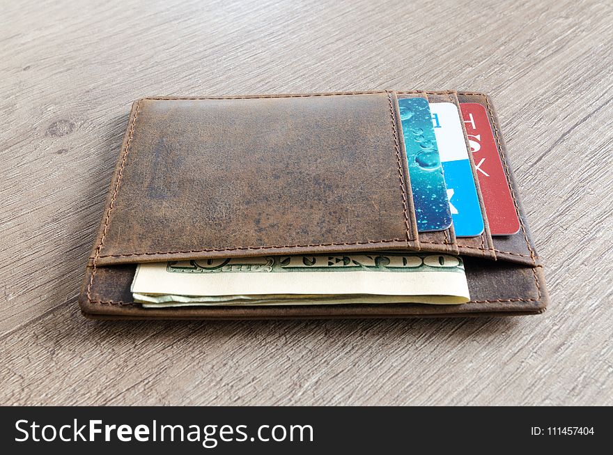 Brown Leather Wallet and Us Dollar Banknote