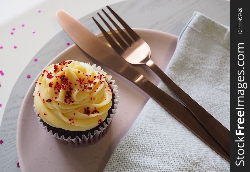 Silver Fork and Knife on Round Plate With Cupcake
