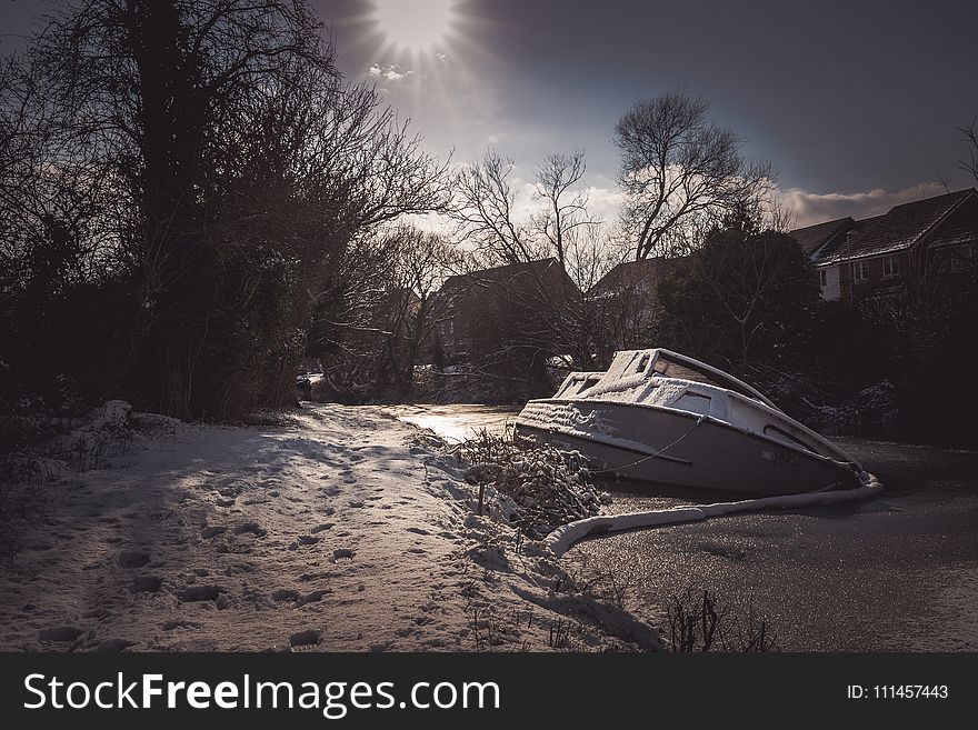 White Yacht on Snowy Pavement