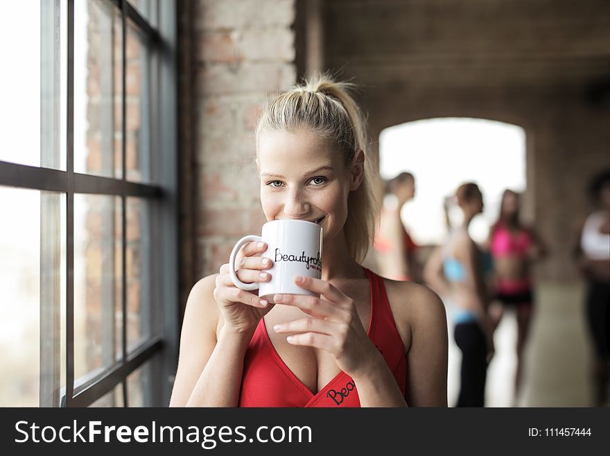 Woman In Red Scoop-neck Tank Top Holding White Mug