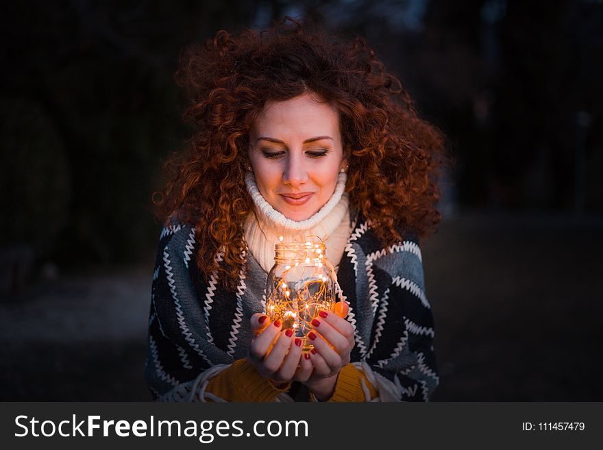 Woman Holding Clear Glass Jar Filled With Lights