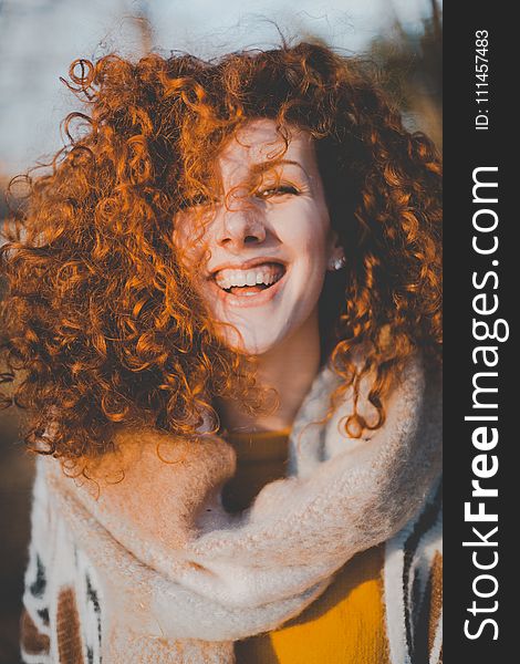 Woman Wearing Gray Knitted Scarf While Smiling