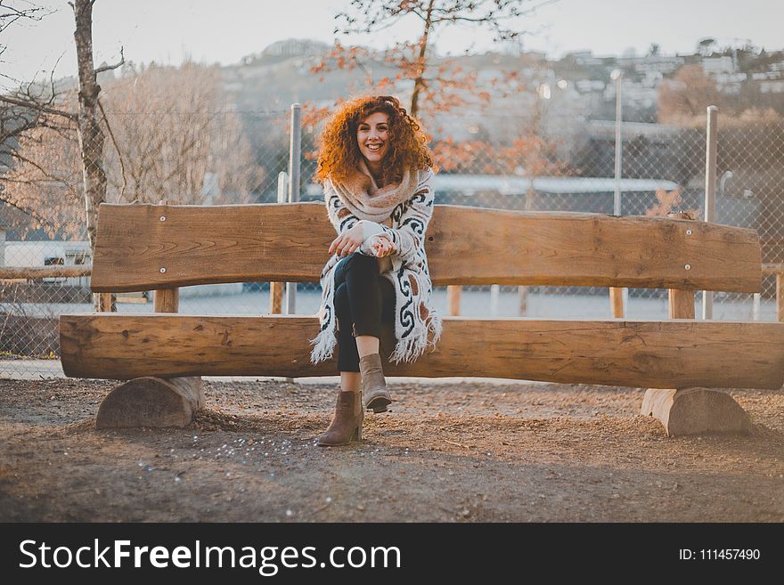 Woman Wearing Floral Cardigan Sit On Bench