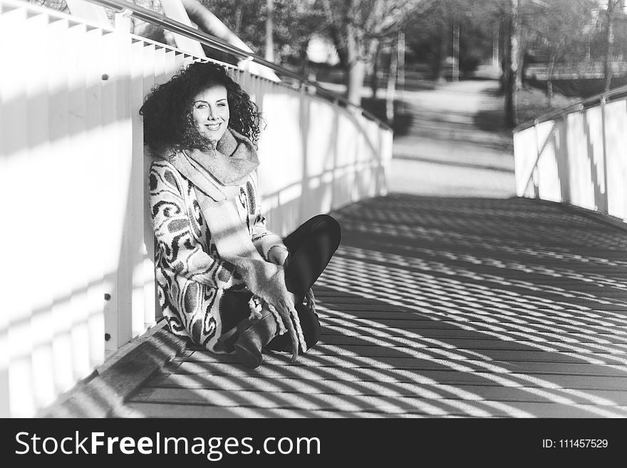 Woman Leaning Near White Metal Rail on Bridge