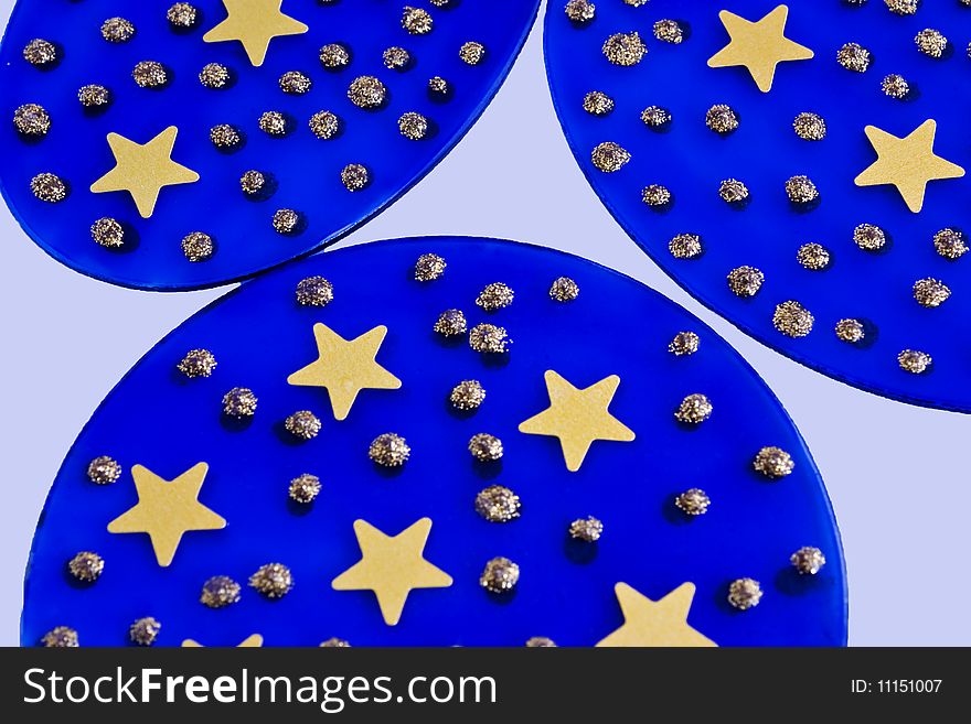 Three blue glass discs with gold stars and dots on then. Three blue glass discs with gold stars and dots on then