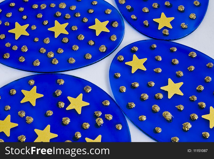 Four blue discs with stars and dots on them. Four blue discs with stars and dots on them