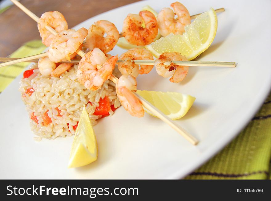 Prawn kebabs with rice and red peppers