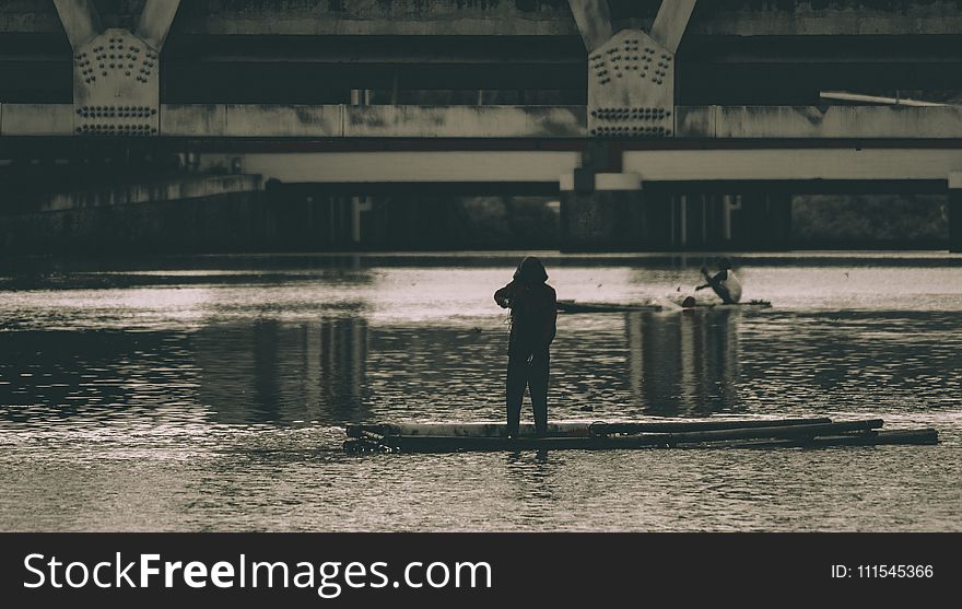Grayscale Photography of a Woman Beside Body of Water