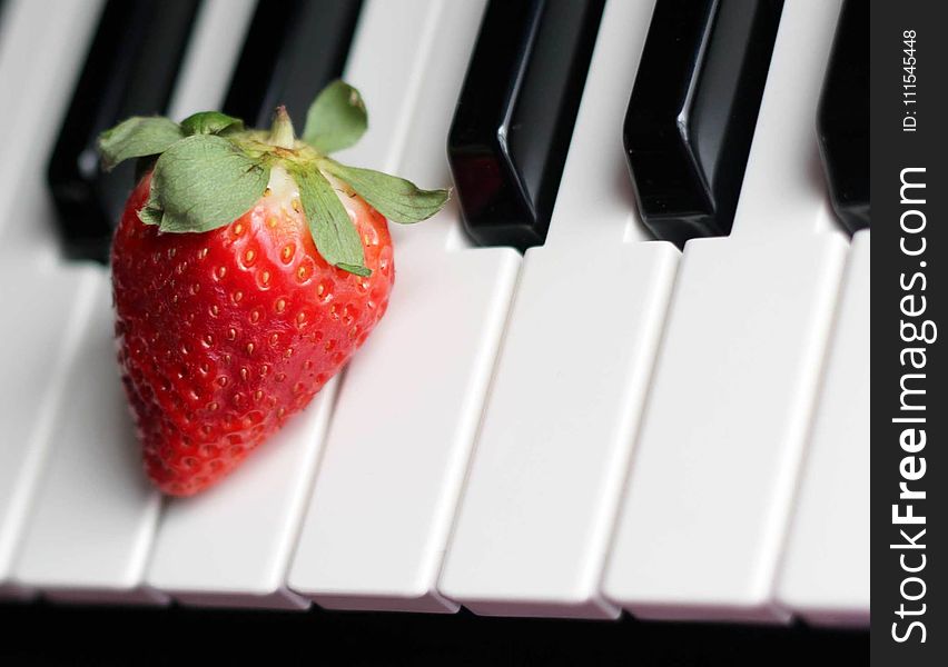 Strawberry on Top of Piano Keys