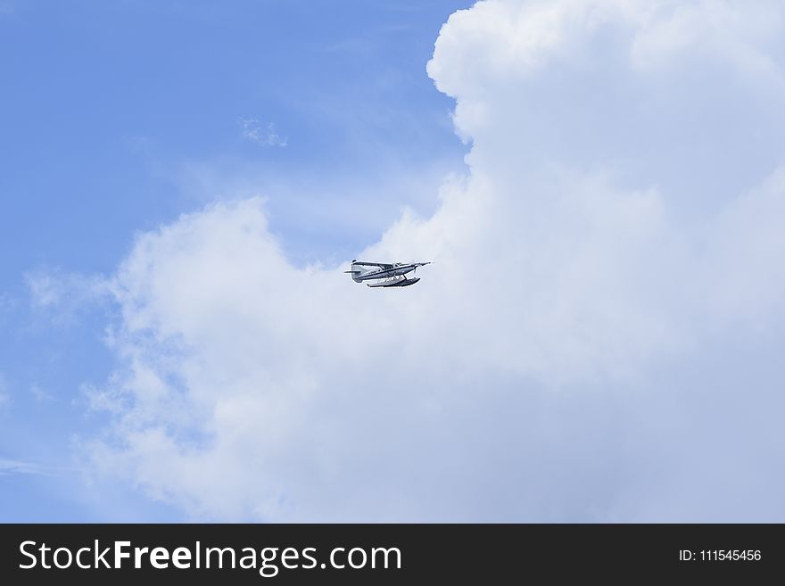 White Hydroplane Flying on the Sky